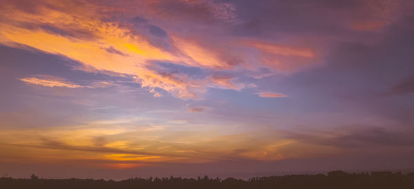 Low angle view of dramatic sky during sunset