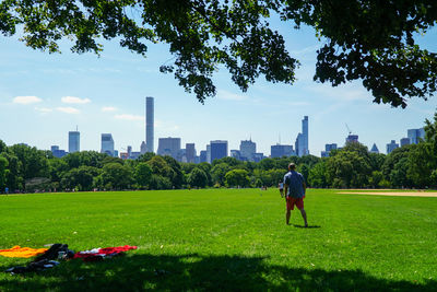 People in park against cloudy sky