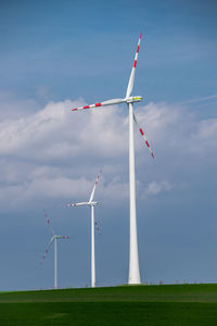 Windmill on field against sky