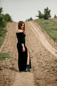 Full length of woman standing on road