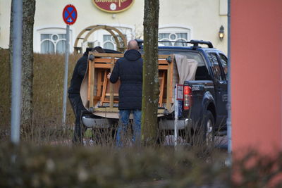 Two men putting furniture into pick-up truck