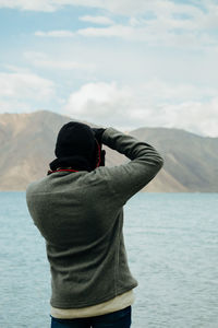 A photographer photographing pangong lake, ladakh, india