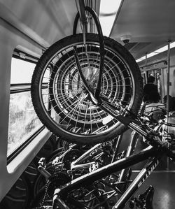 Close-up of bicycle wheels hanging in a train wagon