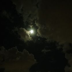 Low angle view of moon in sky at night