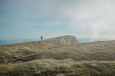 Scenic view of cliff on sea against sky