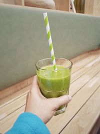 Cropped image of person holding drink