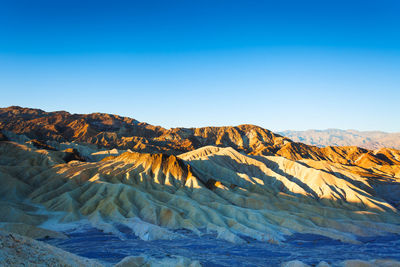 Scenic view of mountain range against clear blue sky