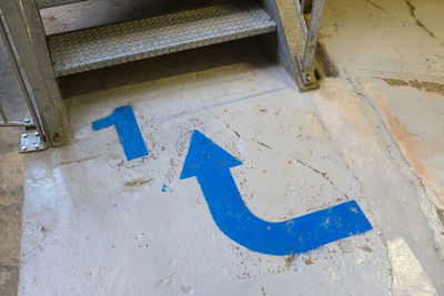 High angle view of arrow sign on wall