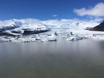 Scenic view of frozen lake against sky