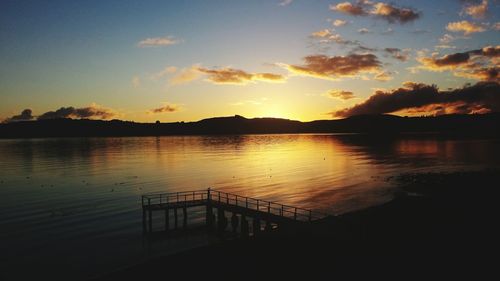 Scenic view of lake at sunset