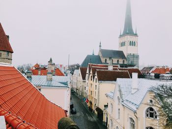 Buildings in city against clear sky