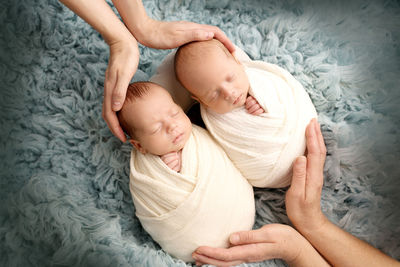 Cute babies lying on bed