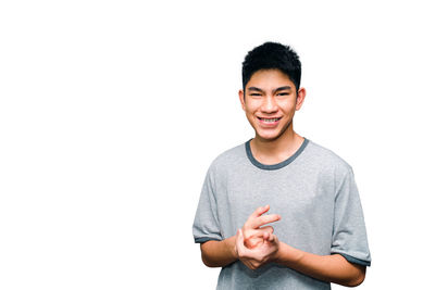 Portrait of a smiling young man against white background