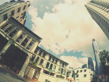 Low angle view of building against cloudy sky