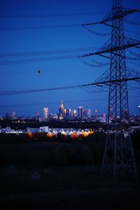 Illuminated cityscape against clear sky at dusk