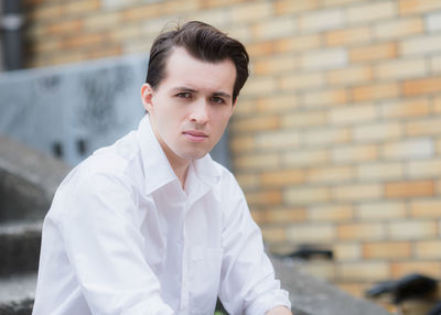 Portrait of young man against wall