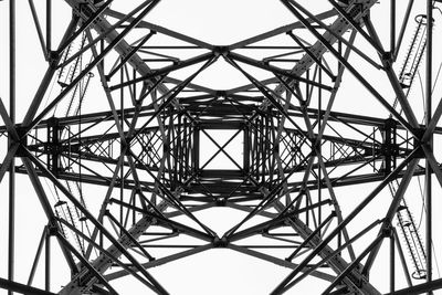 Low angle view of electricity pylon against sky