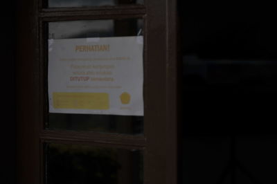 Close-up of text on glass window