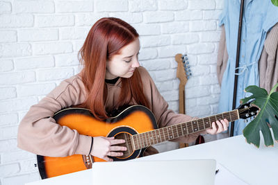 Young woman playing guitar