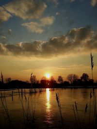Scenic view of lake against sky during sunset