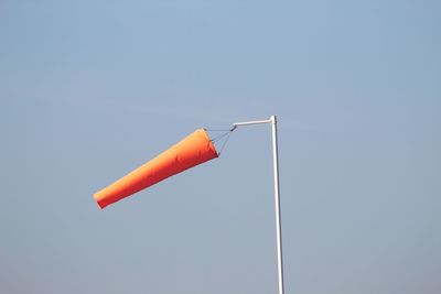 Low angle view of wind sock against clear sky