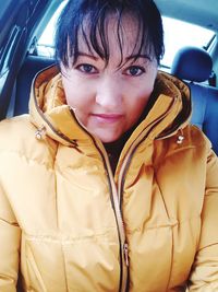 Portrait of smiling young woman sitting in car