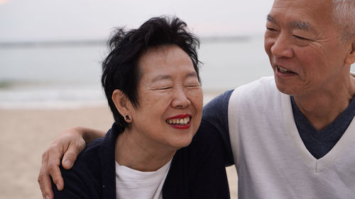 Portrait of couple standing at beach