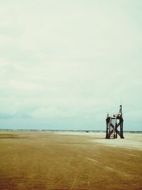 Lifeguard hut at beach against sky