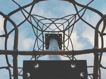 Directly below view of metallic climbing pole against sky