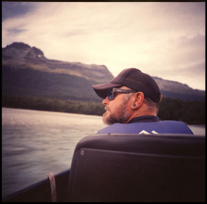 Young man wearing sunglasses on sea against sky