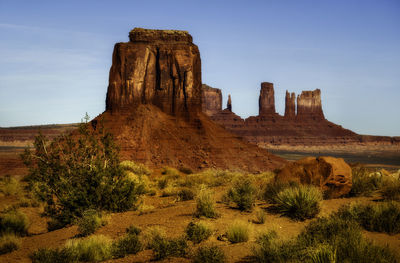 Rock formations on landscape against sky