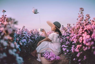 Rear view of woman holding flowers