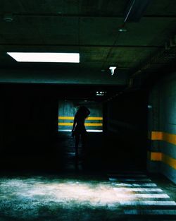 Full length of silhouette man in illuminated room