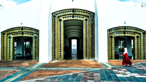 Woman walking outside historic building