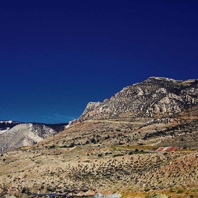 blue, clear sky, landscape, tranquil scene, tranquility, copy space, mountain, scenics, beauty in nature, nature, desert, non-urban scene, arid climate, remote, barren, mountain range, horizon over land, physical geography, geology, rock - object