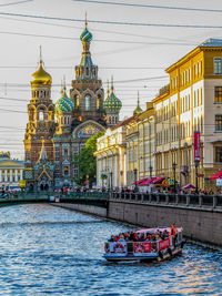 Boats in river with buildings in background