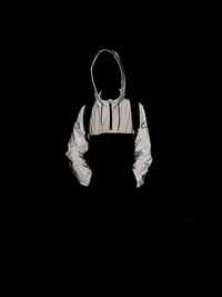 Man with umbrella standing in darkroom