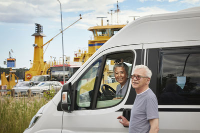 Senior couple getting in van