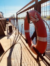 Close-up of rope tied to railing against sea