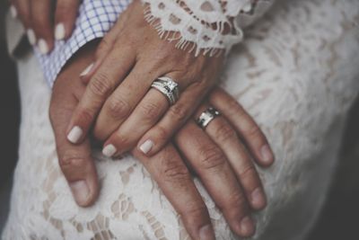 Cropped hand of person with their wedding rings