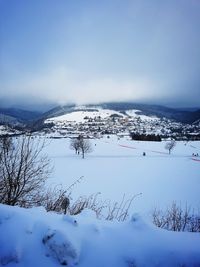 Scenic view of frozen lake against sky during winter