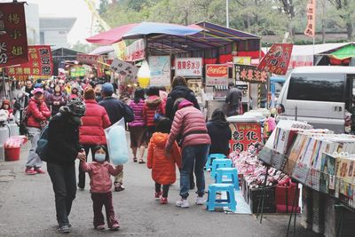 People at market stall in city