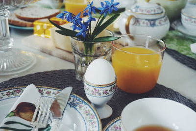 High angle view of boiled egg and juice served on dining table