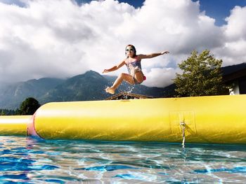 Young woman jumping in water