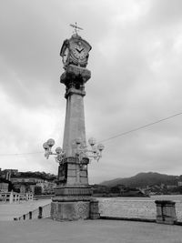 Low angle view of statue against cloudy sky