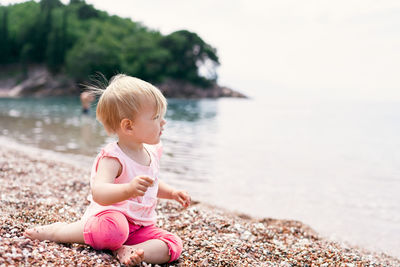 Cute boy sitting on beach