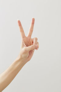 Close-up of human hand over white background