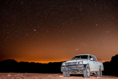 Vintage car on land against sky at night