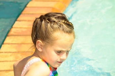 Close-up portrait of boy looking at swimming pool