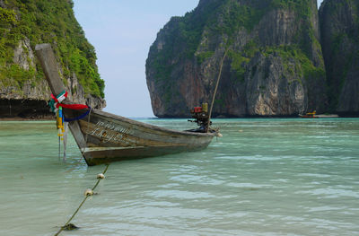 Man on boat in sea against sky